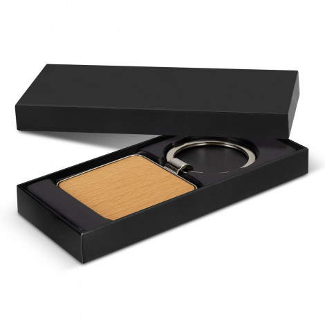 The Santo Key Ring is a square shiny nickel or gunmetal key ring with beech or sapele wood. Durable key chain. Individual black box. Engraving or print ideal.