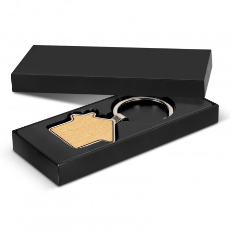 The Santo Key Ring is a house shaped wooden/metal key ring with a stylish key chain. Individual black box. Suitable for engraving or print.